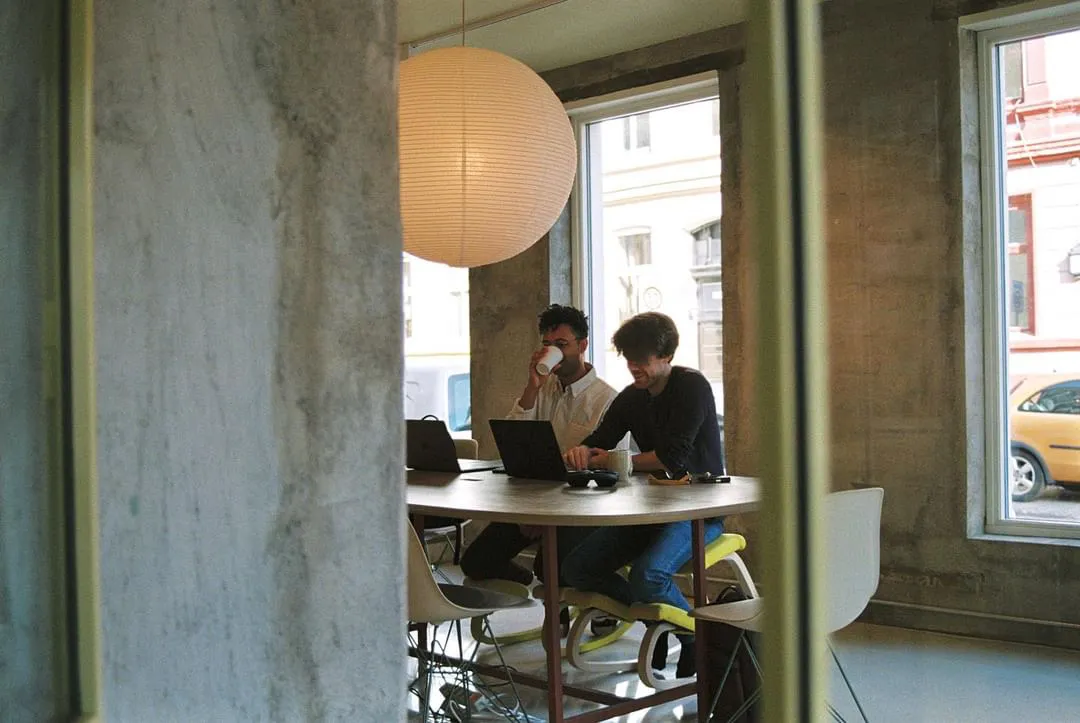 Simon and Espen at work, seen through the window of the Oslo office